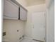 Laundry room with storage cabinets, tile flooring and washer/dryer hookups at 2317 E Lynwood St, Mesa, AZ 85213