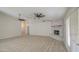 Bright living room with a brick fireplace, tile floors, and a ceiling fan at 2317 E Lynwood St, Mesa, AZ 85213
