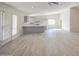 Open living room with gray cabinets, a breakfast bar, and wood-look tile floors at 2317 E Lynwood St, Mesa, AZ 85213