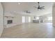 Bright, open living room featuring a white brick fireplace and modern ceiling fans at 2317 E Lynwood St, Mesa, AZ 85213