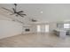 Spacious living room with a brick fireplace, wood-look tile floors, and dual ceiling fans at 2317 E Lynwood St, Mesa, AZ 85213