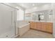 Bathroom with a bathtub, a shower, double sinks, and white countertops at 24580 N 144Th Ave, Surprise, AZ 85387