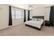 Spacious bedroom with a ceiling fan and large windows for natural light at 24580 N 144Th Ave, Surprise, AZ 85387