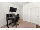 Bedroom with a gaming setup, featuring multiple monitors, a black desk and chair, and white walls with double door closet at 24580 N 144Th Ave, Surprise, AZ 85387
