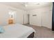 Bright bedroom with carpet floors, a ceiling fan, and an ensuite bathroom at 24580 N 144Th Ave, Surprise, AZ 85387