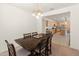 Dining room with a view of the kitchen, a modern chandelier, and a dining table at 24580 N 144Th Ave, Surprise, AZ 85387