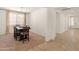 Dining room with a view of the hallway, a modern chandelier, and a dining table at 24580 N 144Th Ave, Surprise, AZ 85387