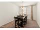 Dining room with a modern chandelier, a dining table, and neutral-colored curtains at 24580 N 144Th Ave, Surprise, AZ 85387