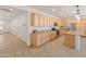 Spacious kitchen featuring stainless steel appliances, granite counters, and light wood cabinets at 24580 N 144Th Ave, Surprise, AZ 85387