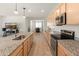 Modern kitchen with granite counters, stainless appliances and opens to dining area and living room at 24580 N 144Th Ave, Surprise, AZ 85387