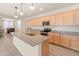 Bright kitchen features a granite island with sink, stainless appliances, and seamless flow into the dining area at 24580 N 144Th Ave, Surprise, AZ 85387