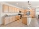 Well-designed kitchen features abundant cabinetry, a large island, and modern lighting fixtures at 24580 N 144Th Ave, Surprise, AZ 85387