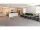Open-concept living area with view of the kitchen and a comfortable sectional sofa at 24580 N 144Th Ave, Surprise, AZ 85387