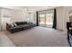 Bright living room featuring a large sectional sofa and a sliding glass door at 24580 N 144Th Ave, Surprise, AZ 85387
