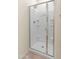 A modern bathroom shower with a glass door and several built-in shelves at 24580 N 144Th Ave, Surprise, AZ 85387