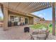 This covered patio has a lounge area for adults and a playset for the  at 25202 N 106Th Dr, Peoria, AZ 85383