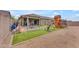 Large backyard featuring a covered patio and a wooden playset at 25202 N 106Th Dr, Peoria, AZ 85383