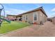 Backyard view showing a covered patio, small garden, and gravel area at 25202 N 106Th Dr, Peoria, AZ 85383