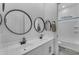 Bathroom featuring double sinks with white cabinets and a bath with neutral decor at 25202 N 106Th Dr, Peoria, AZ 85383