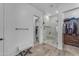 Clean bathroom featuring a tiled shower, access to the closet, and neutral decor at 25202 N 106Th Dr, Peoria, AZ 85383