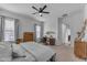 Comfortable bedroom with ceiling fan, work space, and a welcoming, airy feel at 25202 N 106Th Dr, Peoria, AZ 85383