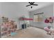 Spacious bedroom with a high bed, desk and a large window view of the outdoors at 25202 N 106Th Dr, Peoria, AZ 85383