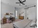 Bright bedroom with a dedicated workspace, ceiling fan, and seamless access to other rooms at 25202 N 106Th Dr, Peoria, AZ 85383