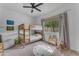 Cozy bedroom with a bunk bed, alphabet rug, and a window view of the outdoors at 25202 N 106Th Dr, Peoria, AZ 85383