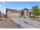 Inviting home with a spacious driveway, two-car garage, and a cozy, covered porch area at 25202 N 106Th Dr, Peoria, AZ 85383