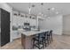 Bright kitchen with modern pendant lighting, stainless steel appliances, and seating at the island at 25202 N 106Th Dr, Peoria, AZ 85383
