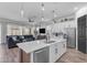 Spacious kitchen with island, stainless steel appliances, and open layout to the living area at 25202 N 106Th Dr, Peoria, AZ 85383