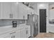 Beautiful kitchen featuring white cabinets, stainless steel appliances, and light gray backsplash at 25202 N 106Th Dr, Peoria, AZ 85383