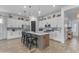 Modern kitchen featuring a spacious island with bar seating, stylish pendant lights, and new appliances at 25202 N 106Th Dr, Peoria, AZ 85383