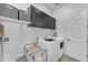 This clean laundry room has black upper cabinets for storage above the included washer and dryer at 25202 N 106Th Dr, Peoria, AZ 85383