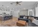 Open concept living area with a large, comfortable gray sofa and a view into the kitchen at 25202 N 106Th Dr, Peoria, AZ 85383