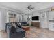Bright living room with a comfortable sofa, modern ceiling fan and TV set at 25202 N 106Th Dr, Peoria, AZ 85383