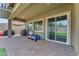 Covered patio with sliding glass doors and outdoor play equipment at 25202 N 106Th Dr, Peoria, AZ 85383