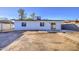 An expansive backyard of a single-story home with white exterior and desert landscaping at 2833 W Marlette Ave, Phoenix, AZ 85017