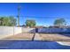 View of a large backyard with block fence and a walkway to the back gate at 2833 W Marlette Ave, Phoenix, AZ 85017