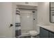 Updated bathroom featuring a tiled shower with a modern showerhead and glass door at 2833 W Marlette Ave, Phoenix, AZ 85017