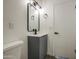 Modern bathroom featuring a sleek vanity, stylish lighting, and neutral color palette at 2833 W Marlette Ave, Phoenix, AZ 85017