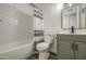Bathroom with tub, shower with stylish curtain, vanity, and modern fixtures at 2833 W Marlette Ave, Phoenix, AZ 85017