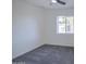 This bedroom features neutral paint, a ceiling fan, cozy carpet, and a window allowing for natural light at 2833 W Marlette Ave, Phoenix, AZ 85017