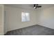 This bedroom features neutral paint, a ceiling fan, cozy carpet, and a window allowing for natural light at 2833 W Marlette Ave, Phoenix, AZ 85017