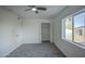 This bedroom features neutral paint, a ceiling fan, cozy carpet, closet, and a door at 2833 W Marlette Ave, Phoenix, AZ 85017