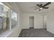 Bedroom featuring neutral carpet, a ceiling fan, a window, and a closet at 2833 W Marlette Ave, Phoenix, AZ 85017