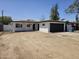Charming single-story home featuring a well-maintained front yard, a dark two-car garage door, and a covered front porch at 2833 W Marlette Ave, Phoenix, AZ 85017