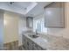 Kitchen featuring granite countertops, gray cabinets, a stainless steel sink, and new flooring at 2833 W Marlette Ave, Phoenix, AZ 85017
