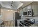 Bright kitchen featuring stainless steel appliances, granite countertops, and ample cabinet space at 2833 W Marlette Ave, Phoenix, AZ 85017