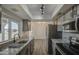 Well-lit kitchen features granite countertops, stainless steel appliances, and modern finishes at 2833 W Marlette Ave, Phoenix, AZ 85017